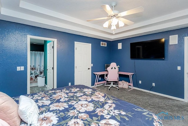 bedroom with baseboards, a raised ceiling, visible vents, and carpet flooring