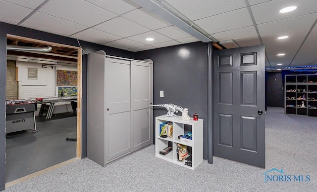 recreation room with a drop ceiling and recessed lighting