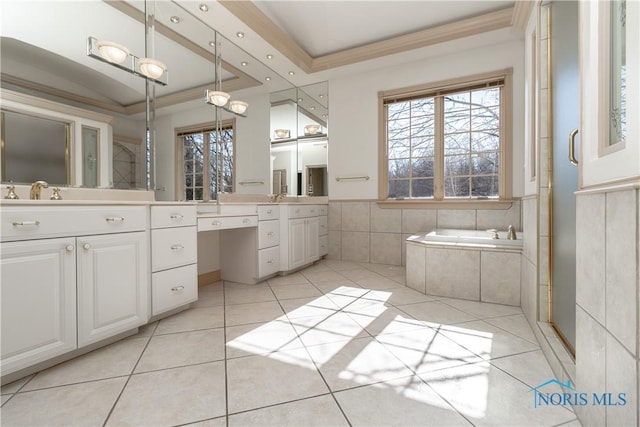 full bath featuring tile patterned flooring, tile walls, a garden tub, vanity, and a raised ceiling