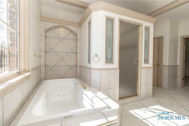 bathroom featuring tile patterned flooring, tile walls, a whirlpool tub, and a shower stall