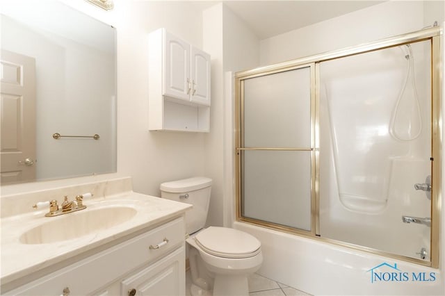 full bath with tile patterned floors, toilet, vanity, and bath / shower combo with glass door