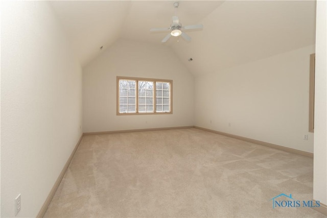 bonus room featuring a ceiling fan, lofted ceiling, light colored carpet, and baseboards