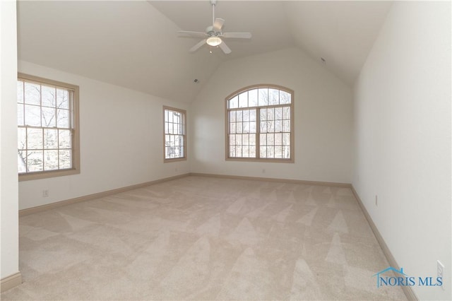 unfurnished room with a ceiling fan, vaulted ceiling, carpet, and baseboards