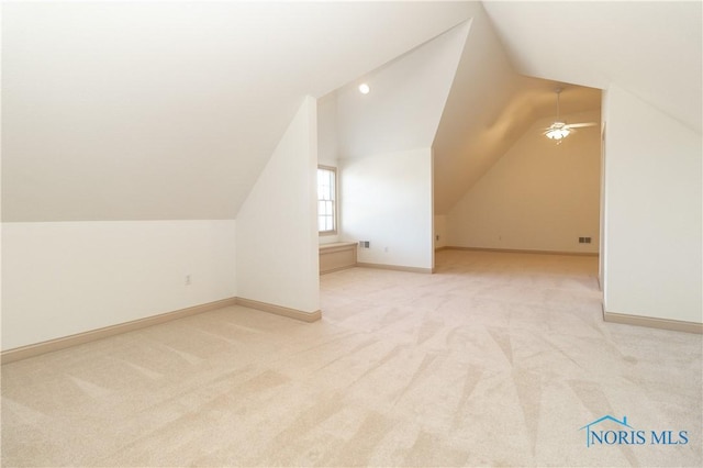 bonus room with baseboards, lofted ceiling, ceiling fan, and carpet floors