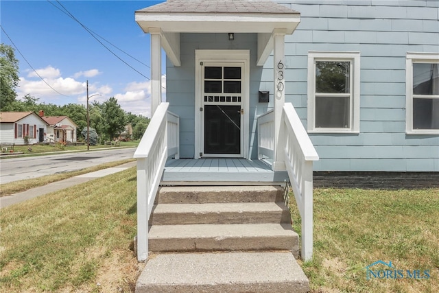 entrance to property with a yard