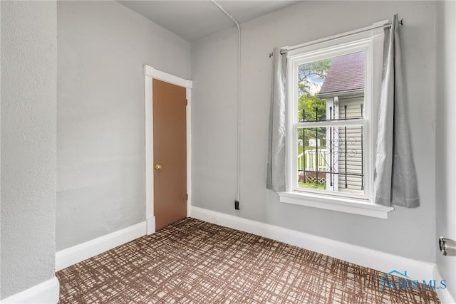 spare room featuring baseboards