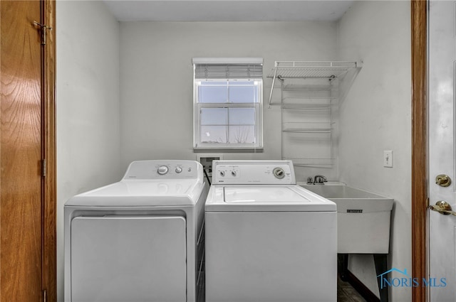 laundry area with a sink, laundry area, and washing machine and clothes dryer