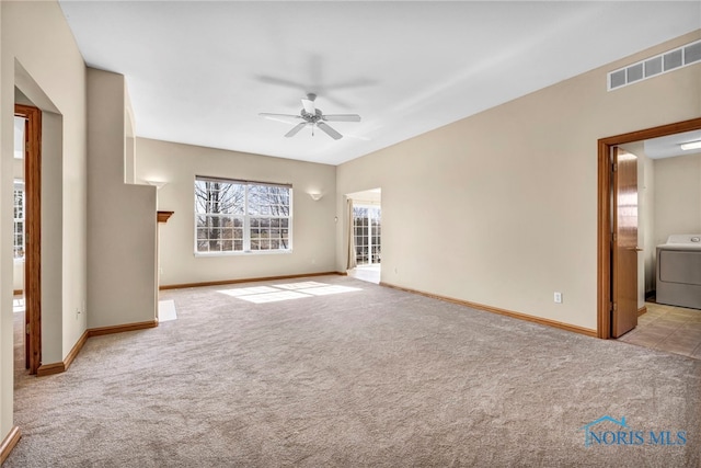 interior space with visible vents, baseboards, washer / dryer, and ceiling fan