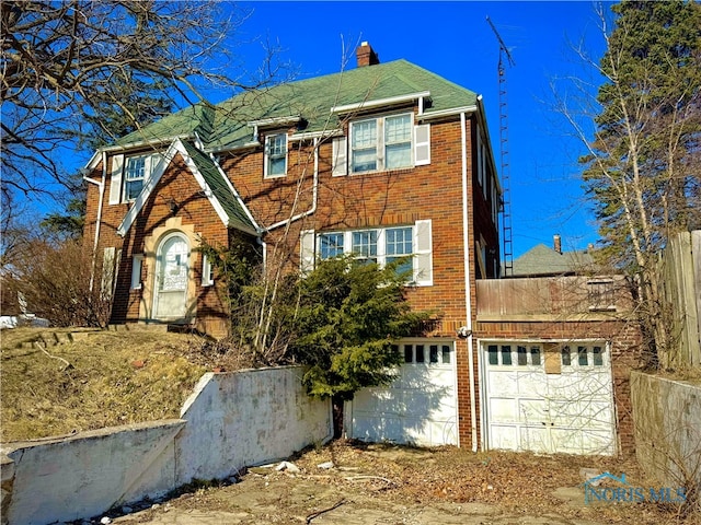 view of front of home featuring fence and brick siding