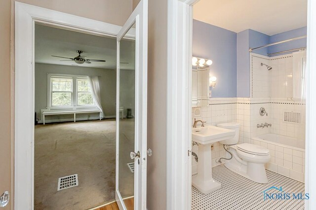 121 Eagle Point Dr, Rossford, OH 43460 - bathroom with toilet, tiled shower / bath, tile patterned floors, a ceiling fan, and a sink