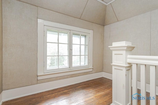 121 Eagle Point Dr, Rossford, OH 43460 - spare room with wood-type flooring, vaulted ceiling, and baseboards