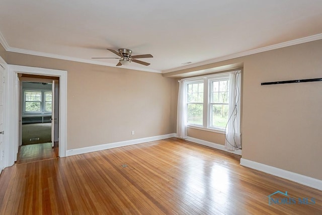 121 Eagle Point Dr, Rossford, OH 43460 - empty room featuring ceiling fan, crown molding, wood finished floors, and baseboards