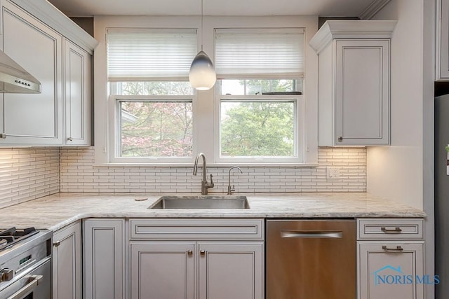 121 Eagle Point Dr, Rossford, OH 43460 - kitchen featuring a sink, appliances with stainless steel finishes, backsplash, light stone counters, and decorative light fixtures