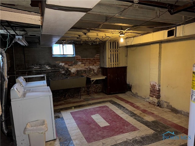 basement with washer and dryer and a sink