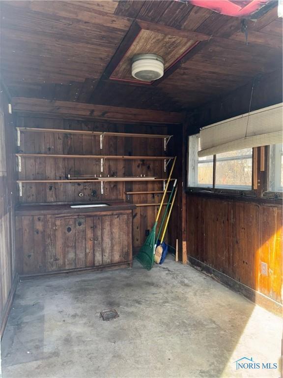 interior space with wooden ceiling and wood walls