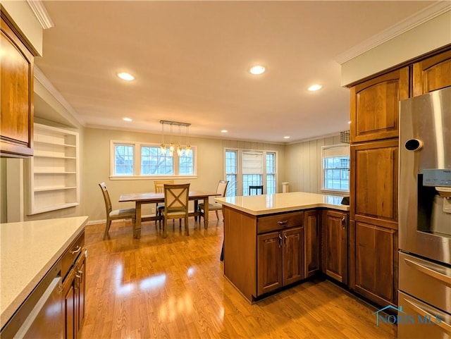 509 Oakwood Ave, Bryan, OH 43506 - kitchen featuring light countertops, wood finished floors, a peninsula, stainless steel refrigerator with ice dispenser, and ornamental molding