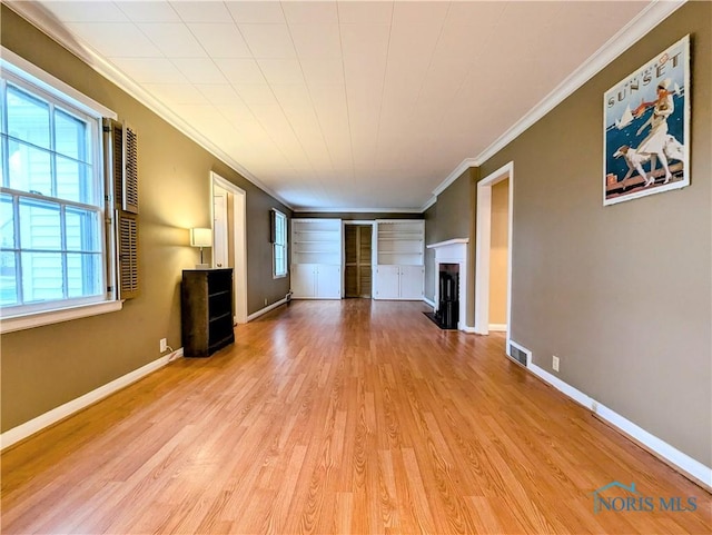 509 Oakwood Ave, Bryan, OH 43506 - unfurnished living room featuring baseboards, a fireplace, wood finished floors, and crown molding