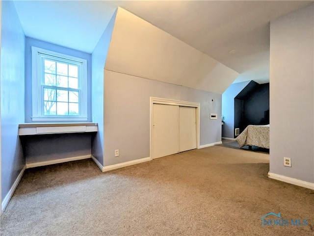 509 Oakwood Ave, Bryan, OH 43506 - bonus room with baseboards, lofted ceiling, and carpet floors