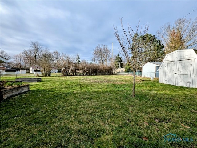 509 Oakwood Ave, Bryan, OH 43506 - view of yard with a storage unit, an outbuilding, fence, and a garden