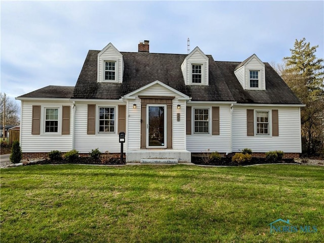 509 Oakwood Ave, Bryan, OH 43506 - cape cod house featuring a chimney, roof with shingles, and a front lawn