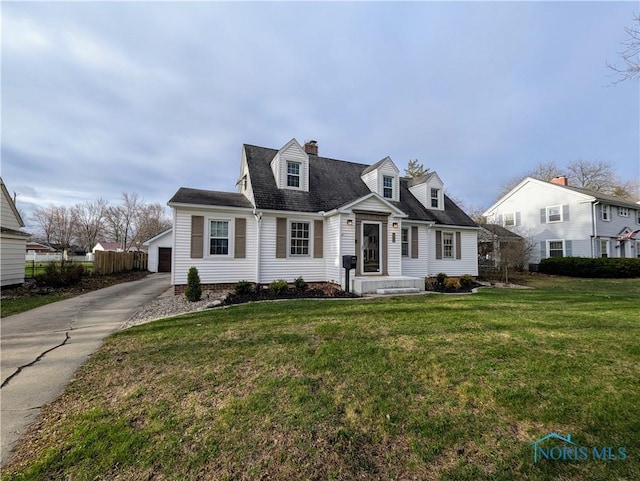 509 Oakwood Ave, Bryan, OH 43506 - cape cod-style house with a front yard, a garage, and fence