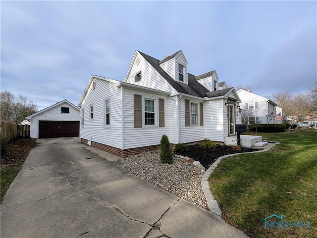 509 Oakwood Ave, Bryan, OH 43506 - view of front of property featuring fence, a front yard, a detached garage, and an outdoor structure