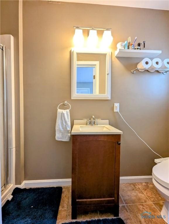 509 Oakwood Ave, Bryan, OH 43506 - bathroom with a stall shower, tile patterned floors, toilet, vanity, and baseboards