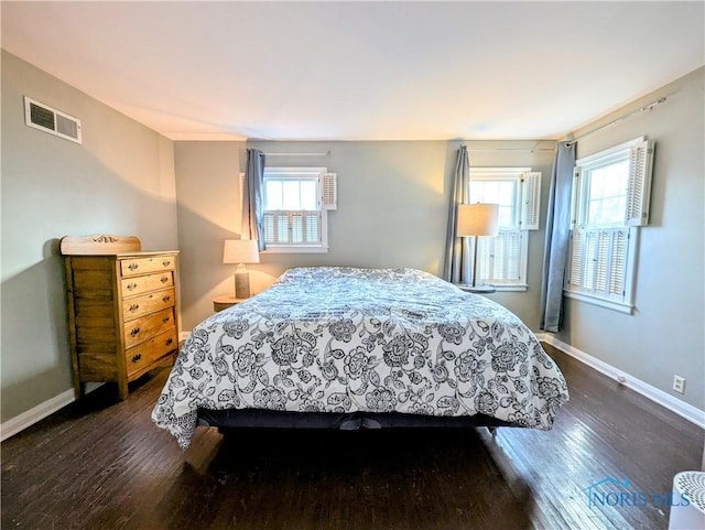 509 Oakwood Ave, Bryan, OH 43506 - bedroom featuring baseboards, dark wood-style floors, and visible vents