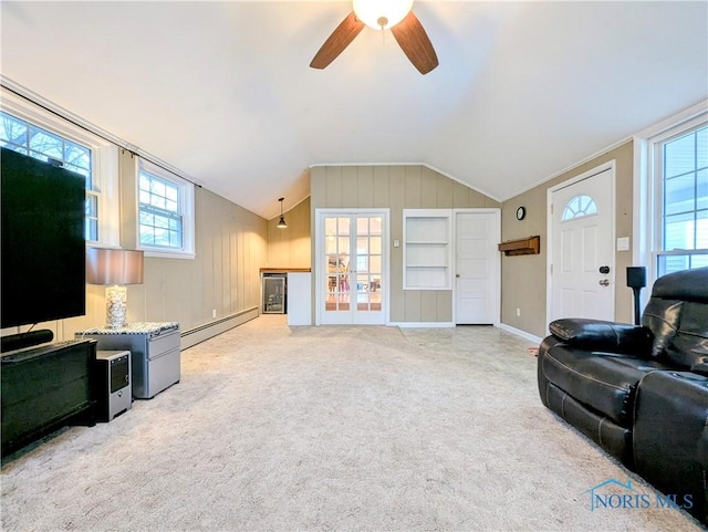 509 Oakwood Ave, Bryan, OH 43506 - living room featuring wooden walls, baseboard heating, lofted ceiling, light colored carpet, and ceiling fan