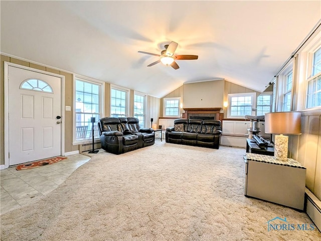 509 Oakwood Ave, Bryan, OH 43506 - carpeted living room with a baseboard radiator, a ceiling fan, and vaulted ceiling