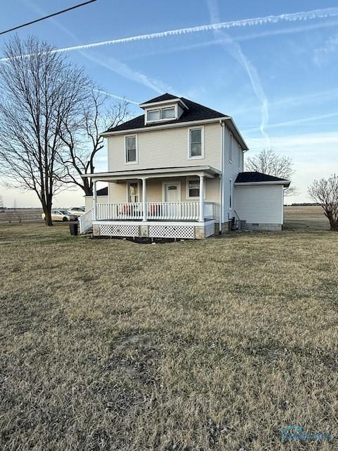 american foursquare style home featuring covered porch and a front lawn