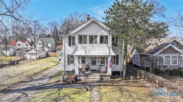 1522 Watova Rd, Toledo, OH 43614 - view of front facade with a front yard, fence, covered porch, and a chimney