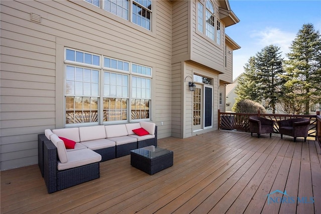 wooden terrace with an outdoor hangout area