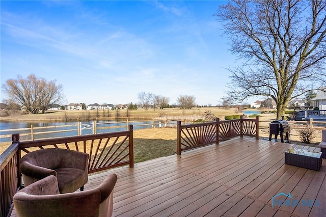 wooden deck featuring a water view and a grill