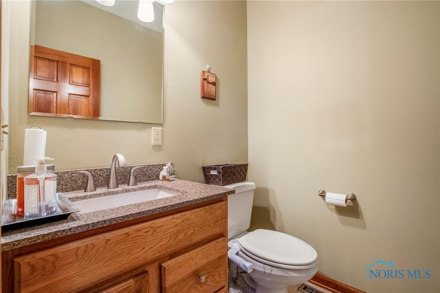 half bath with toilet and vanity