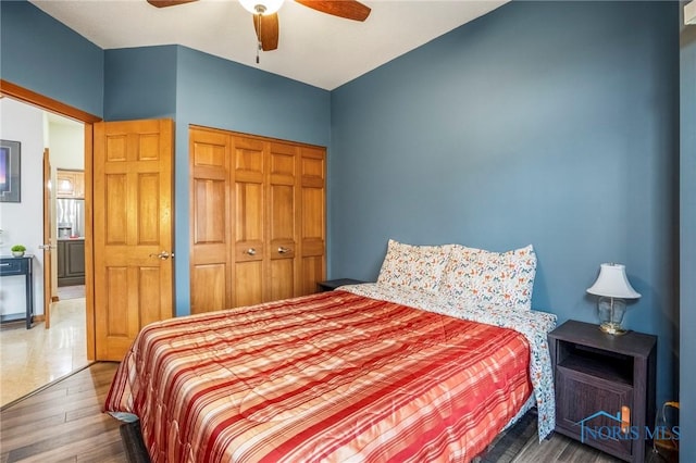 bedroom featuring a closet, ceiling fan, and wood finished floors