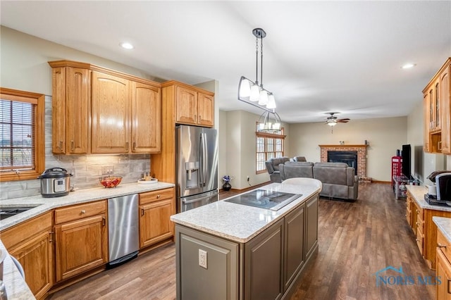 kitchen featuring tasteful backsplash, a kitchen island, stainless steel fridge with ice dispenser, black electric cooktop, and dark wood-style flooring