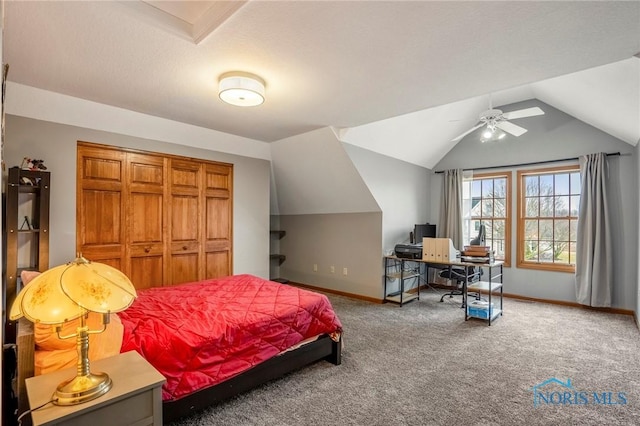 carpeted bedroom featuring vaulted ceiling, a ceiling fan, baseboards, and a closet