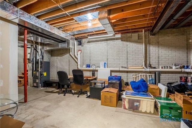 unfinished basement with heating unit and brick wall