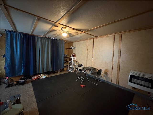 interior space with heating unit and ceiling fan