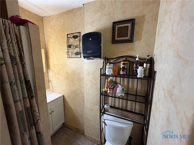 bathroom with vanity, tile patterned floors, and toilet