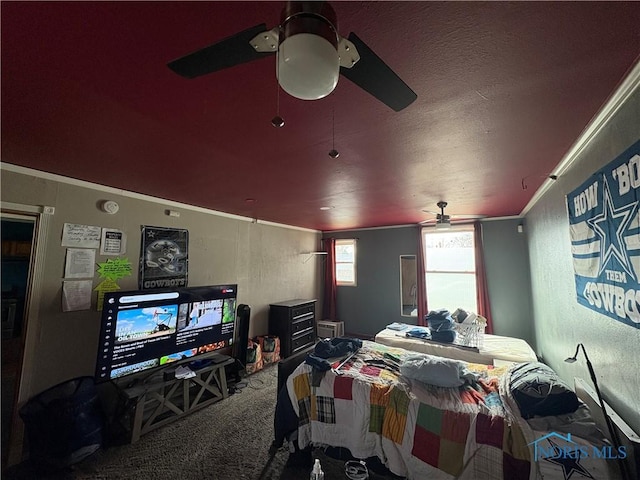 carpeted bedroom with ceiling fan, a textured ceiling, a textured wall, and ornamental molding