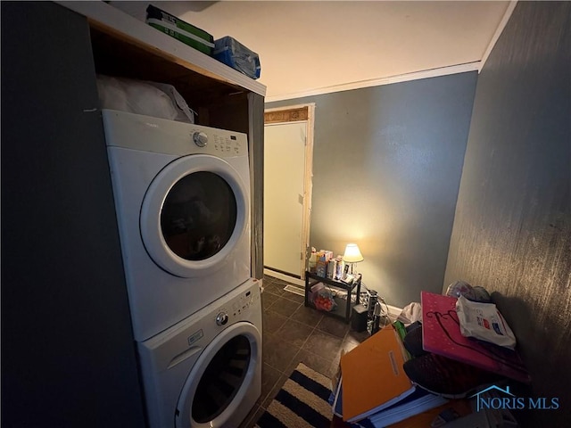 washroom with tile patterned flooring, laundry area, and stacked washing maching and dryer