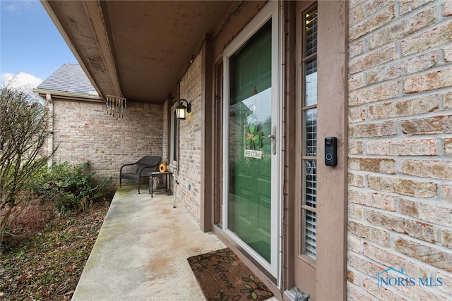 entrance to property with brick siding