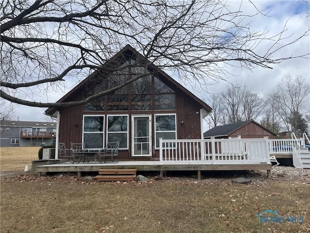 rear view of property featuring a deck