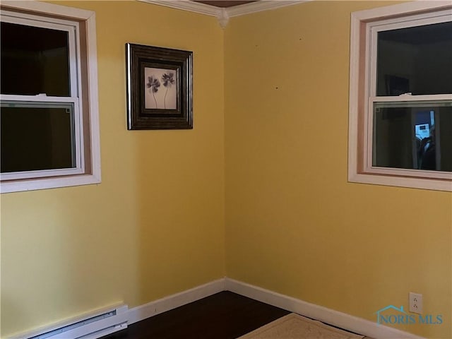 spare room with ornamental molding, baseboards, and a baseboard radiator