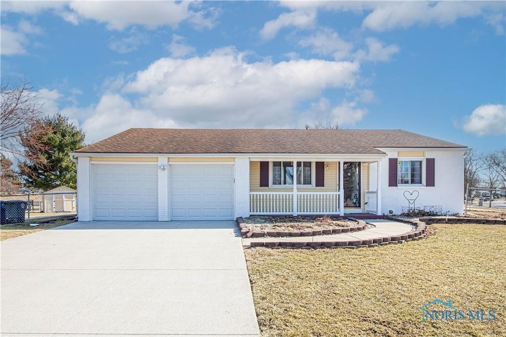 single story home featuring fence, driveway, a porch, a front lawn, and a garage