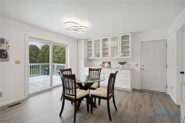 1004 Waterville Monclova Rd, Waterville, OH 43566 - dining space with light wood-style flooring, baseboards, and visible vents