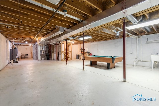 1004 Waterville Monclova Rd, Waterville, OH 43566 - unfinished basement with gas water heater, billiards, and a sink