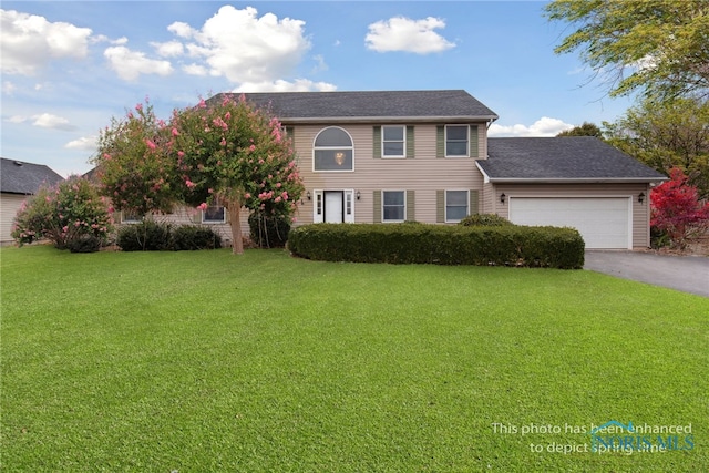 1004 Waterville Monclova Rd, Waterville, OH 43566 - colonial home with aphalt driveway, an attached garage, and a front lawn